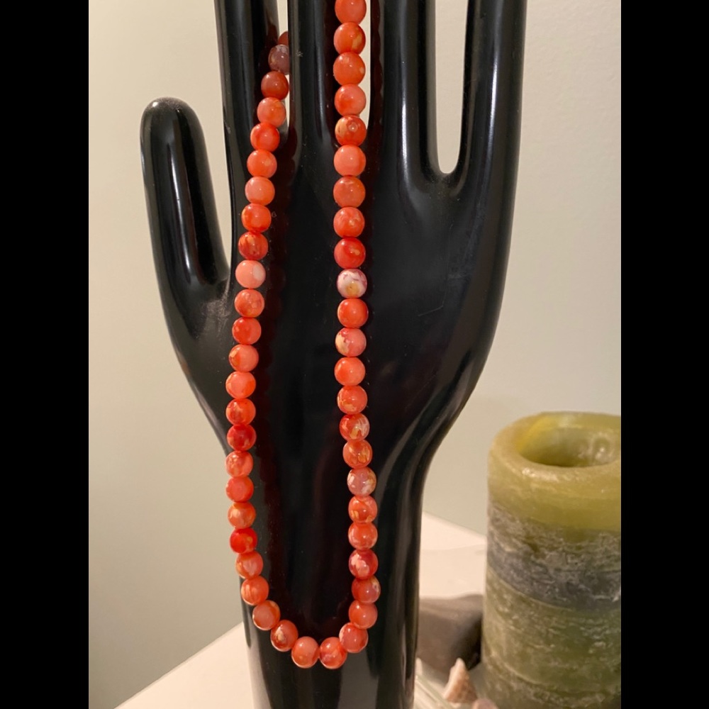 Coral colored plastic bead necklace